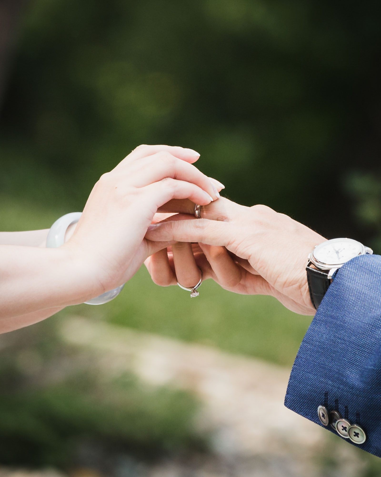 Image description: The bride wears a ring for the groom.